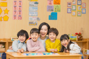 Kindergarten teacher playing with children